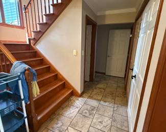 Once you enter, turn left to access stairs to upstairs bedrooms, stairs to go down to basement, and first level bedroom.