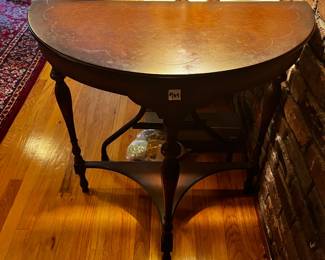 #104 Wood veneer Half-Moon Table w/scallop carved top and Bottom Shelf - (chip on top and wear on bottom) - 30x15x32 $75.00