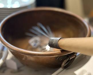 Lots of copper cookware and bowls.