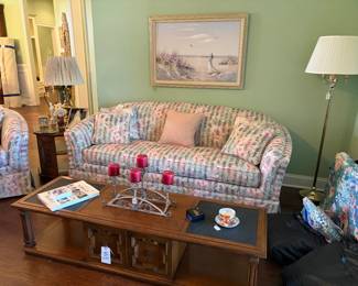floral sofa, coffee table, painting, pole lamp, decor