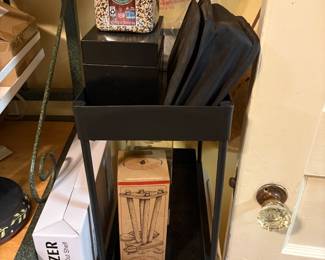 Small metal table on top of 3 drawer plastic item for more storage - box in left is a new in box organizer