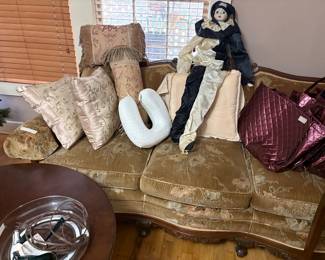 Vintage sofa in living room with pillows, etc.