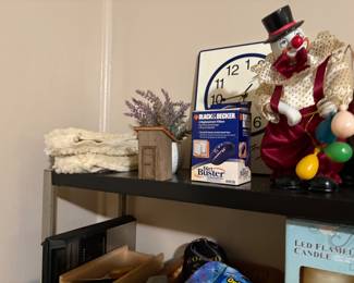 Top of shelf - large clown, clock dust buster in box and miscellaneous