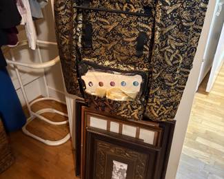 Bedroom & items outside closet - frames on bottom and dirty clothes container in backgroudn