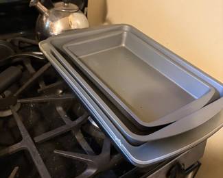 Baking pans & silver tea kettle in kitchen
