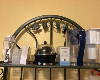 Top shelf of organizer with egg cooker, pitchers & miscellaneous