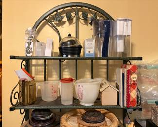 Second shelf contains measuring cup, Tupperware container & mixing bowl with lid - last items are recipe container & cookbooks
