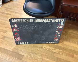 Stool behind vintage chalk board
