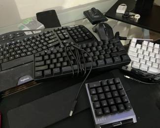 Collection of Computer Peripherals including Logitech Wave, White 60% Mechanical Keyboard, and Mechanical Numpad