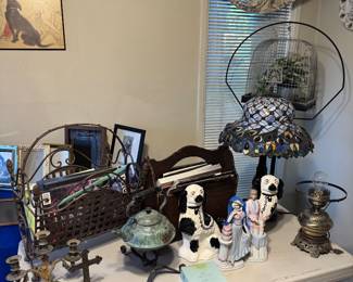 vintage Tiffany-style stained glass table lamp featuring a decorative patterned shade with blue, purple, and iridescent tones., black and white Staffordshire spaniel dog figurine, Southern Living at Home "Acanthus" Wrought Iron Centerpiece Basket, magazine holder,