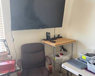 Wall Mounted Television And Small Desk