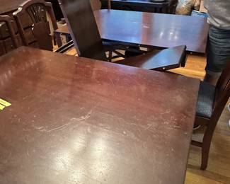 Dining table has a "Nested Leaf" that folds down under the table top when not in use.