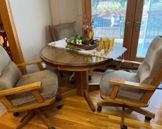 Oak kitchen table with adjustable chairs.