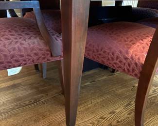 View of the mahogany table legs/base of the dining table and chairs