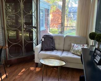 Loveseat with oval coffee/cocktail table in burnished brass and another view of the curio cabinet