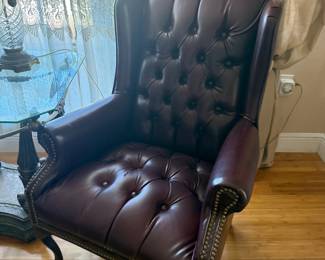 Burgundy leather tufted wingback chair with nailhead trim