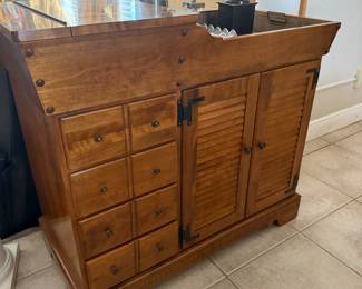 Wooden dry sink cabinet with louvered doors and multiple drawers
