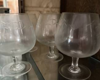 Etched glass brandy snifters with cut floral design, set of three