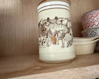 Lidded ceramic canister with painted musicians and street scene