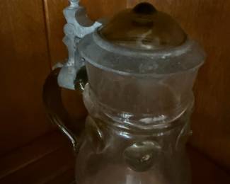 Glass beer stein with hinged pewter lid and thumb lift
