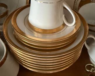 Gold rimmed china saucers with matching cup, stacked set