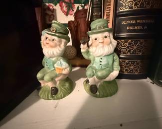 Pair of ceramic leprechaun figurines in green suits