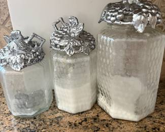 Glass canisters with grape-cluster metal lids, set of three