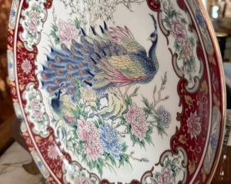 Porcelain plate with peacock and floral design, red border