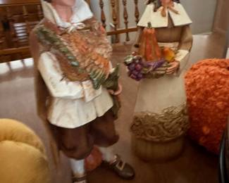 Life-size pilgrim couple figures with harvest baskets, pair