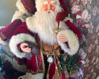 Life-size Santa Claus figure in red velvet coat with bell