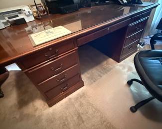 Cherry wood executive desk with glass top and dual drawer pedestals