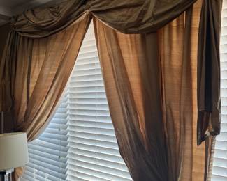 Silk drapery panels with swagged valance in bronze gold