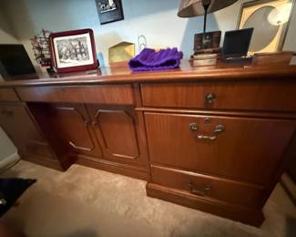 Wood credenza with cabinet doors, drawers, and brass pulls