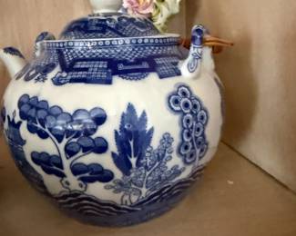 Blue willow pattern teapot with wicker-wrapped handle