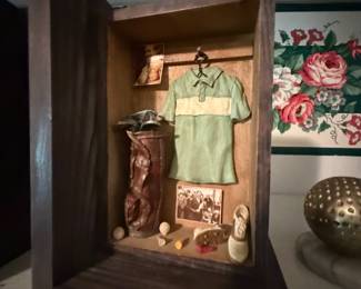 Miniature golfer's locker diorama with tiny shirt, bag, and shoes