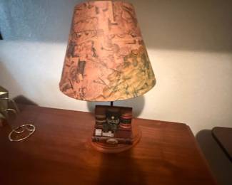 Table lamp with stacked-books base and golf print shade