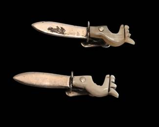 These are small clips made of bone or similar. They may be decorative tie clips but seem smaller than that.