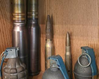 Vintage pineapple grenade, baseball grenade, and brass artillery shells