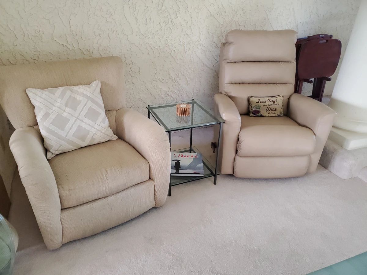 Two recliners (manual). One fabric, one leather great condition