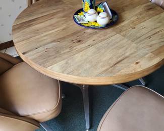 Kitchen table (42" rnd), 4 leather covered swivel chairs on casters.