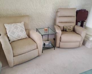 Two recliners (manual). One fabric, one leather great condition