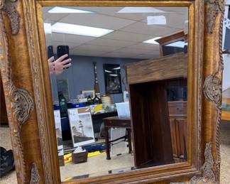 Large mirror with ornate gold frame