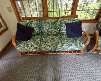 2. Rattan loveseat with tropical cushions