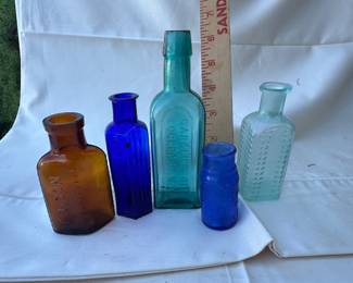 Variety of Glass Bottles including Poison & Caroline Oil