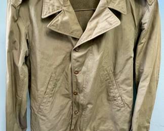  original, authentic World War II U.S. Army M1941 field jacket with custom "nose art" style trench art, featuring a hand-painted pin-up girl titled "Slave Girl"