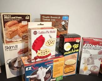 Collection of Vintage Kitchen Gadgets including Pie Mold, Loaf Pans, Egg Machine, and More