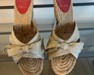 Christian Louboutin gold metallic wedge mules.