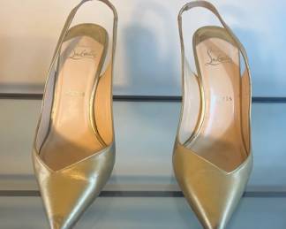 Gold slingback pumps by Christian Louboutin