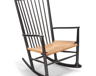 2143 Hans Wegner (1914-2007) A model J16 rocking chair for FDB Mobler, mid-20th century Designed 1944 Inspired by Windsor and Shaker furniture styles, the black lacquered wood chair with spindle back and curvilinear armrests above a woven jute cording seat, the legs joined by bar stretchers and set on rockers Height 42 1/4 in., width 25 in., depth 32 in. Estimate: $500 - $700