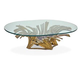 2085 Attributed to Isabel Masson-Faure (b. 1940) & Richard Faure (20th Century) A sea anemone form amethyst and gilt metal coffee table, second half 20th century Gilt copper piping centered by an amethyst specimen, with single light nested between the metal elements and specimen, surmounted by an oval glass top Appears unmarked Height of base 17 1/4 in., width 48 in., depth 41 1/4 in.; height of glass 7/8 in., width 60 1/4 in., depth 46 in. Estimate: $3,000 - $5,000